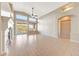 Bright living room boasts vaulted ceilings, a fireplace, and sliding glass doors to the outdoor space at 10253 E Indigo Dr, Scottsdale, AZ 85255