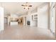 Open-concept living space showcasing a fireplace, views into the kitchen, and access to the outdoor area at 10253 E Indigo Dr, Scottsdale, AZ 85255