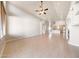 Bright, open living space with tile flooring, a ceiling fan, and easy access to the kitchen area at 10253 E Indigo Dr, Scottsdale, AZ 85255