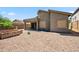 Backyard view of house with stone fountain and desert landscaping with private block fence at 10591 E Morning Star Dr, Scottsdale, AZ 85255
