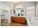 Inviting primary bathroom offers a double sink vanity, soaking tub, and a walk-in closet at 10591 E Morning Star Dr, Scottsdale, AZ 85255