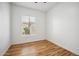 Neutral bedroom with wood-look flooring, window with backyard view, and ceiling fan at 10591 E Morning Star Dr, Scottsdale, AZ 85255