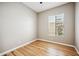 Neutral bedroom with wood-look flooring and window with a private backyard view at 10591 E Morning Star Dr, Scottsdale, AZ 85255
