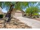 Single story home with desert landscaping, a two car garage and a long driveway at 10591 E Morning Star Dr, Scottsdale, AZ 85255
