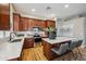 Bright kitchen boasts wooden cabinetry, stainless steel appliances, and a center island with barstool seating at 10591 E Morning Star Dr, Scottsdale, AZ 85255