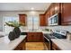 Updated kitchen features wooden cabinets, stainless appliances, and a window over the sink at 10591 E Morning Star Dr, Scottsdale, AZ 85255