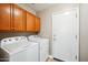 Laundry room featuring a large washer and dryer as well as mounted cabinets at 10591 E Morning Star Dr, Scottsdale, AZ 85255