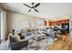Open-concept living area with large sectional sofa, ceiling fan, and view to the kitchen at 10591 E Morning Star Dr, Scottsdale, AZ 85255