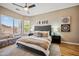 Comfortable primary bedroom features a ceiling fan, large windows, and plush bedding at 10591 E Morning Star Dr, Scottsdale, AZ 85255