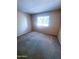 Simple bedroom with plush carpeting and a bright window with blinds at 1075 E Chandler Blvd # 220, Chandler, AZ 85225