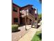 View of a multi-story apartment building with exterior stairs, a landscaped path, and neutral paint at 1075 E Chandler Blvd # 220, Chandler, AZ 85225