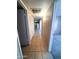 Tile hallway leading to a kitchen with white appliances and tan walls at 1075 E Chandler Blvd # 220, Chandler, AZ 85225