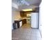 Efficient kitchen with white appliances, a corner sink, and light tile flooring at 1075 E Chandler Blvd # 220, Chandler, AZ 85225