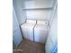 Convenient laundry room featuring a stacked washer and dryer unit with shelving at 1075 E Chandler Blvd # 220, Chandler, AZ 85225
