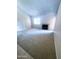 Neutral living room with plush carpeting, a modern fireplace, and a view of a large window at 1075 E Chandler Blvd # 220, Chandler, AZ 85225