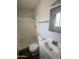 A full bathroom features a toilet, sink, mirror, and standing shower with shelves at 11802 N 25Th Ave, Phoenix, AZ 85029