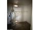 Functional utility room featuring a water heater and shelving, providing storage space at 11802 N 25Th Ave, Phoenix, AZ 85029