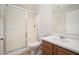 Neutral bathroom featuring a shower with glass doors, wood cabinet, and a single sink vanity at 11845 W Edgemont Ave, Avondale, AZ 85392
