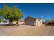 View of the home featuring a two-car garage and low-maintenance desert landscaping at 11845 W Edgemont Ave, Avondale, AZ 85392