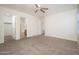 Primary bedroom featuring plush carpeting, walk in closet, and an ensuite bathroom at 11845 W Edgemont Ave, Avondale, AZ 85392