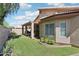 Well-maintained backyard features green grass, covered patio, privacy fence, and garden area at 11861 E Becker Ln, Scottsdale, AZ 85259