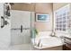 Luxurious bathroom with a separate glass-enclosed shower, soaking tub and modern fixtures at 11861 E Becker Ln, Scottsdale, AZ 85259