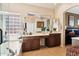 Bright bathroom with a soaking tub, dual sinks, and vanity in a neutral color palette at 11861 E Becker Ln, Scottsdale, AZ 85259