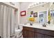 Bright bathroom features a double sink vanity, neutral color scheme, and shower with striped curtain at 11861 E Becker Ln, Scottsdale, AZ 85259