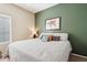 Cozy bedroom with accent wall, comfortable bed with throw pillows, and a large window at 11861 E Becker Ln, Scottsdale, AZ 85259