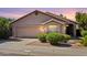 Charming single-story home featuring a two-car garage, desert landscaping, and a neutral color palette at 11861 E Becker Ln, Scottsdale, AZ 85259