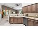 Gourmet kitchen featuring granite countertops, stainless steel appliances, and seamless flow to the dining room at 11861 E Becker Ln, Scottsdale, AZ 85259