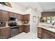 Modern kitchen featuring stainless steel appliances, granite countertops, and ample cabinet space at 11861 E Becker Ln, Scottsdale, AZ 85259