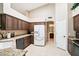 Contemporary kitchen with granite counters, ample cabinetry, stainless steel appliances and seamless flow to the bathroom at 11861 E Becker Ln, Scottsdale, AZ 85259