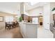 Bright open kitchen with granite countertops, stainless appliances, and connected breakfast nook area at 11861 E Becker Ln, Scottsdale, AZ 85259