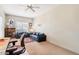 Bright living room with two blue sofas, beige carpet, and a ceiling fan for comfortable living at 11861 E Becker Ln, Scottsdale, AZ 85259