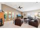 Spacious living room with high ceilings, neutral paint, a ceiling fan, and access to the backyard patio at 11861 E Becker Ln, Scottsdale, AZ 85259