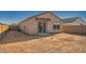 View of the backyard with partial fencing, sliding glass doors, and ample space for outdoor activities at 12013 E Primrose Ln, Florence, AZ 85132