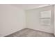 Empty bedroom boasts a window with blinds, neutral paint, and gray carpet at 12142 E Sunflower Ln, Florence, AZ 85132