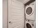 A stackable white washer and dryer set are conveniently located in this home's laundry area at 12142 E Sunflower Ln, Florence, AZ 85132