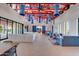 A community lounge space features sofas, blue accents, and access to outdoors at 12142 E Sunflower Ln, Florence, AZ 85132