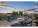Inviting backyard with a seating area, a fire pit, and decorative lighting at 12152 W Briles Rd, Peoria, AZ 85383