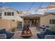 Backyard with outdoor lounge seating, a fire pit, and a grill perfect for entertaining at 12152 W Briles Rd, Peoria, AZ 85383