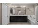 A relaxing bathroom features a granite countertop vanity, oversized mirror and soaking tub at 12152 W Briles Rd, Peoria, AZ 85383