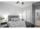 Comfortable bedroom features a ceiling fan, closet and a soft, inviting bed at 12152 W Briles Rd, Peoria, AZ 85383