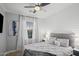Comfortable bedroom features a ceiling fan, window, and a soft, inviting bed at 12152 W Briles Rd, Peoria, AZ 85383