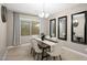 Elegant dining room with a wood table, seating for six, and decorative mirrors at 12152 W Briles Rd, Peoria, AZ 85383