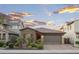 Charming single-story home featuring brick accents, a two-car garage, and desert landscaping at 12152 W Briles Rd, Peoria, AZ 85383