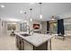 Bright open-concept kitchen featuring a large island with seating and modern finishes at 12152 W Briles Rd, Peoria, AZ 85383