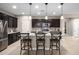 Modern kitchen with an island and breakfast bar seating, stainless steel appliances, and pendant lighting at 12152 W Briles Rd, Peoria, AZ 85383