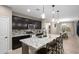 Modern kitchen features granite countertops, dark cabinetry, and stainless steel appliances at 12152 W Briles Rd, Peoria, AZ 85383